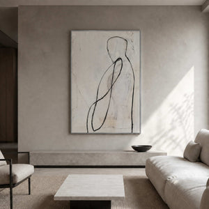 Neutral figurative artwork displayed in a softly plastered residential living room.