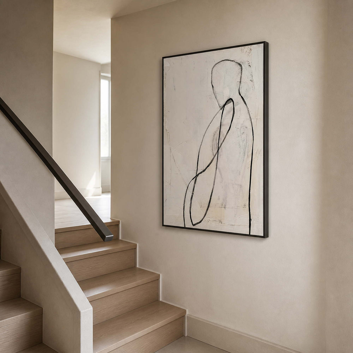 Black line figurative artwork viewed beside a warm residential staircase.