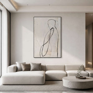 Minimalist figurative wall art displayed above a warm white modern living room.