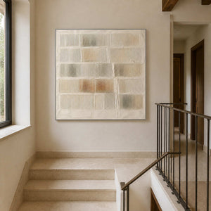 Textured neutral painting viewed in a pale stone stair hall.