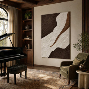 Frameless brown and ivory abstract wall art beside a grand piano and green armchair.
