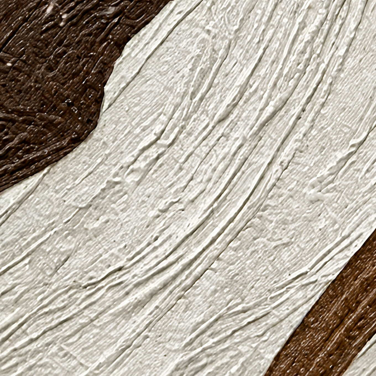Close-up of diagonal raised ivory grooves bordered by dark brown textured paint.