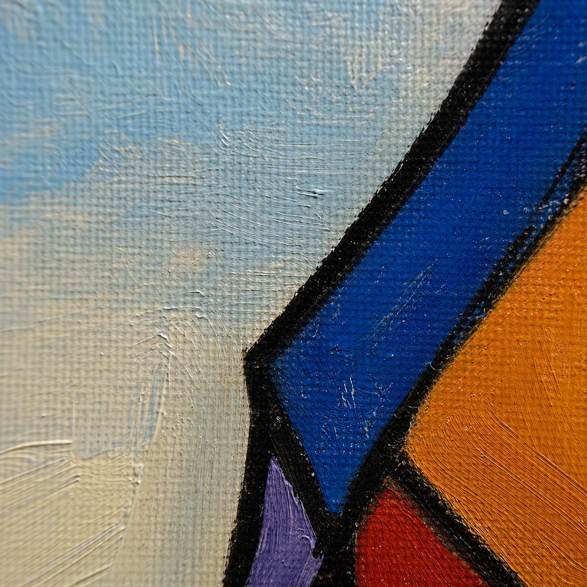 Close-up of hand-painted blue, orange, red, and black contours on canvas.