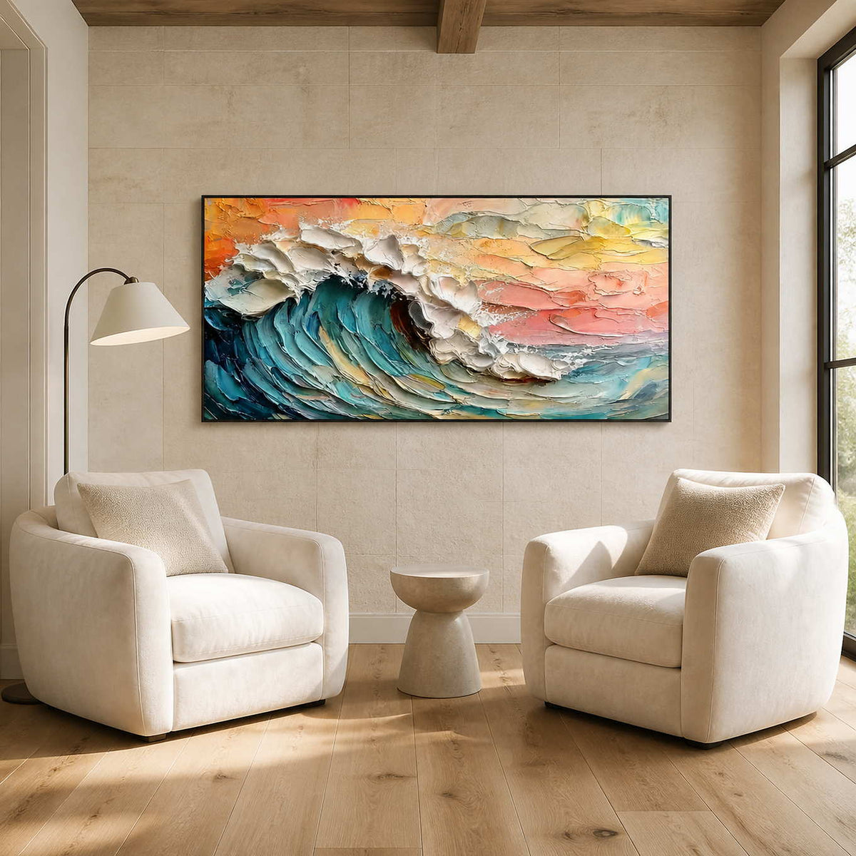 Black framed wave painting above two cream reading chairs and a small pedestal table.