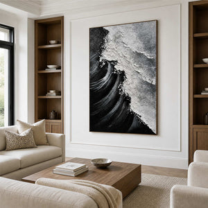 Wood framed wave artwork with dark sweeping curves above seating in a walnut family room.
