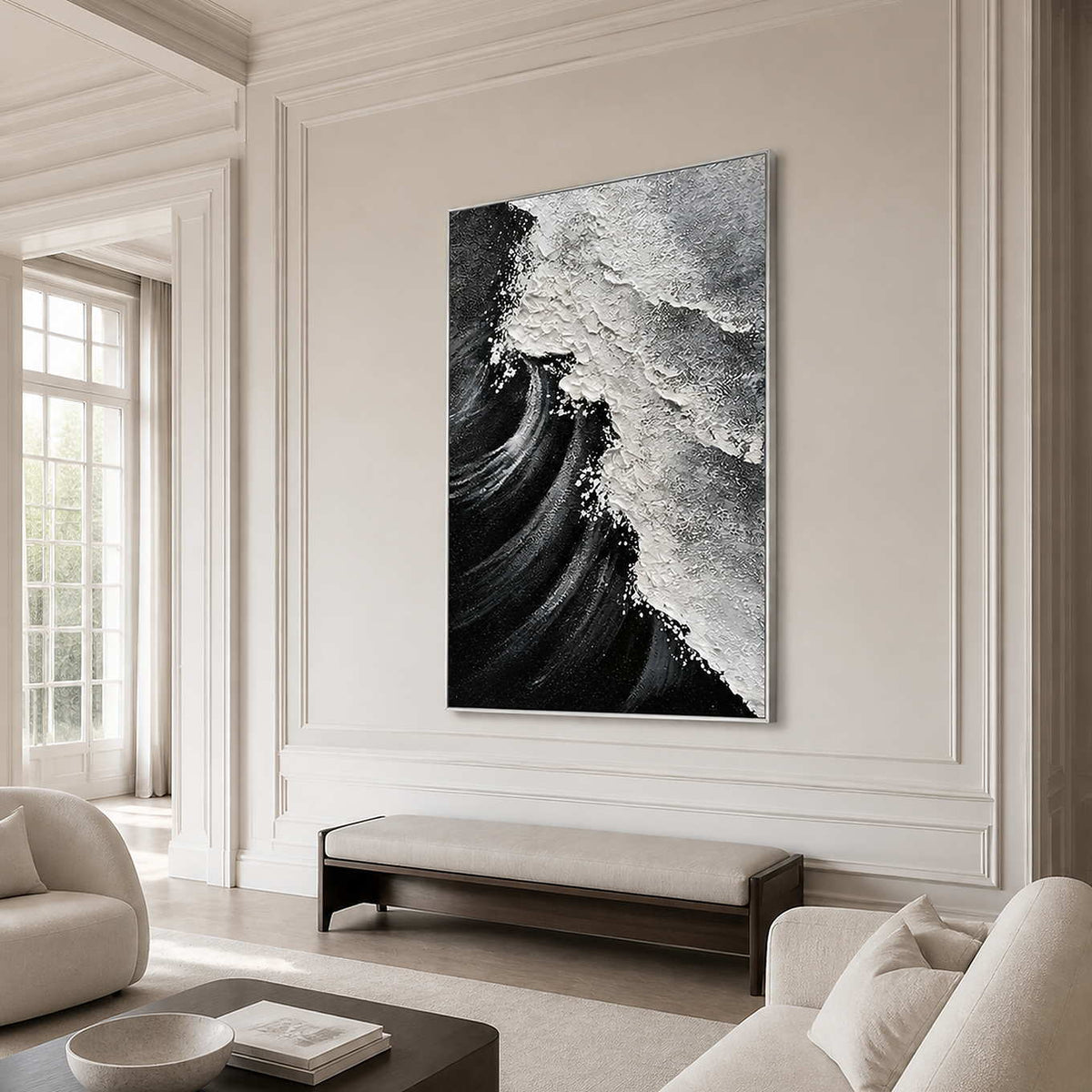 Silver framed monochrome coastal painting above a long bench in an ivory sitting room.