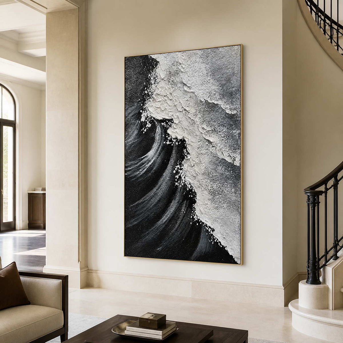 Gold framed coastal artwork with diagonal breaking foam beside a curved staircase.