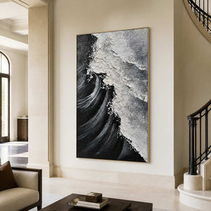Gold framed coastal artwork with diagonal breaking foam beside a curved staircase.