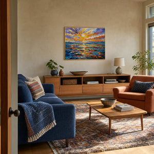 Colorful sunset seascape wall art displayed in a warm coastal living room.