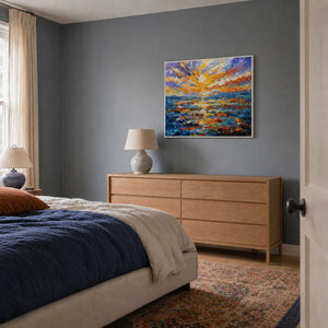 Blue and gold seascape wall art styled above a warm gray bedroom dresser.