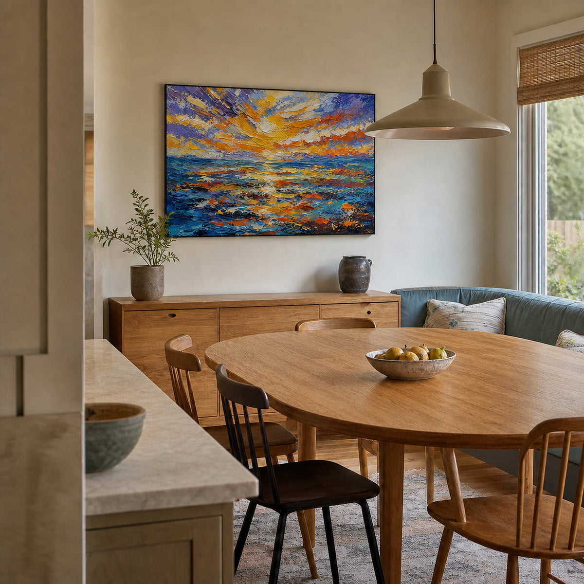 Textured sunset seascape displayed in a warm wood dining room.