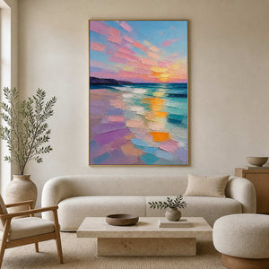 Pastel sunset coastal wall art in a soft neutral modern living room.