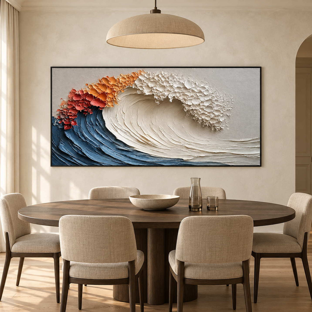 Orange-crested wave painting above an oval dining table under a wide beige pendant.