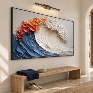 Blue-wave painting over a slatted wooden entryway bench beneath a picture light.