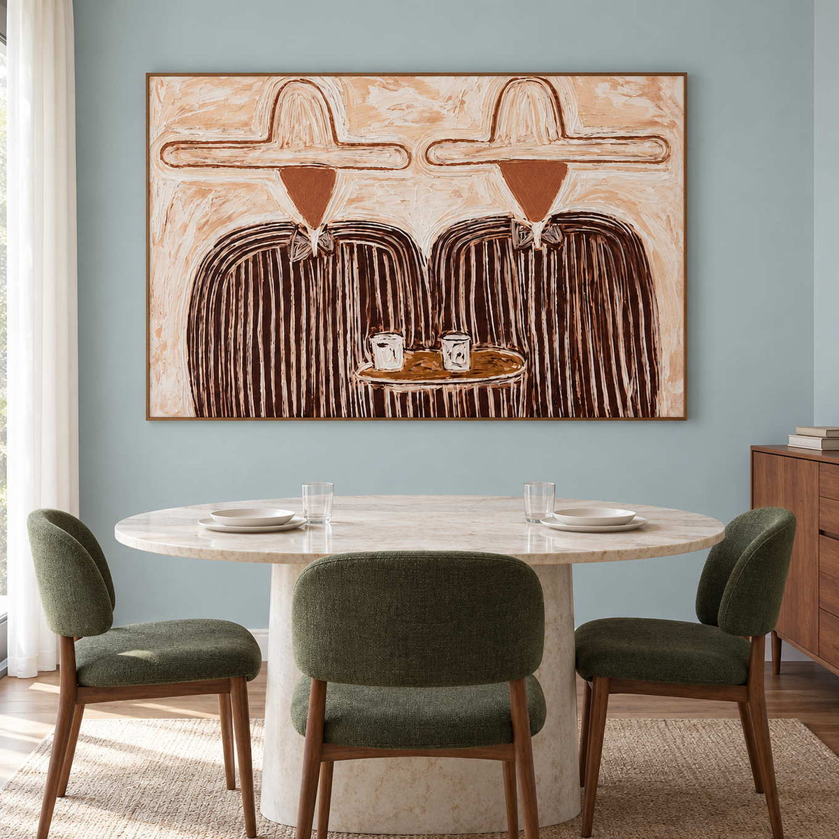 Shared-table artwork behind a round dining table with green chairs.