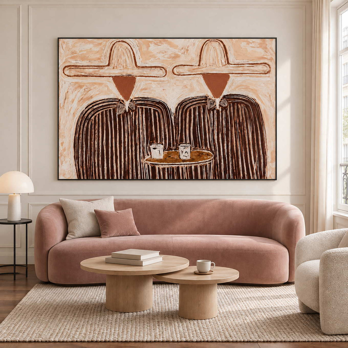 Two-cup portrait above a curved blush sofa.