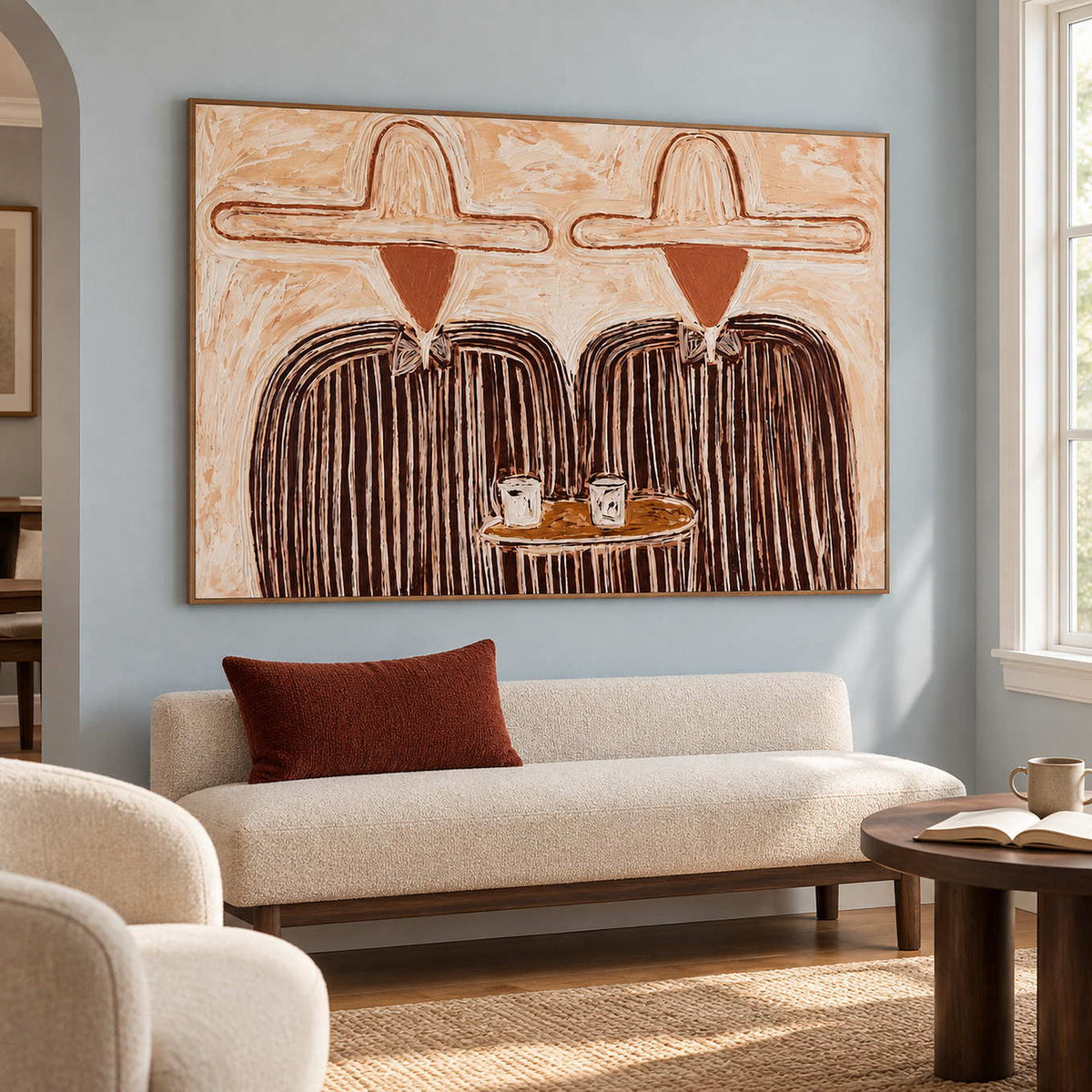Cream-and-brown portrait above a pale settee on a blue wall.