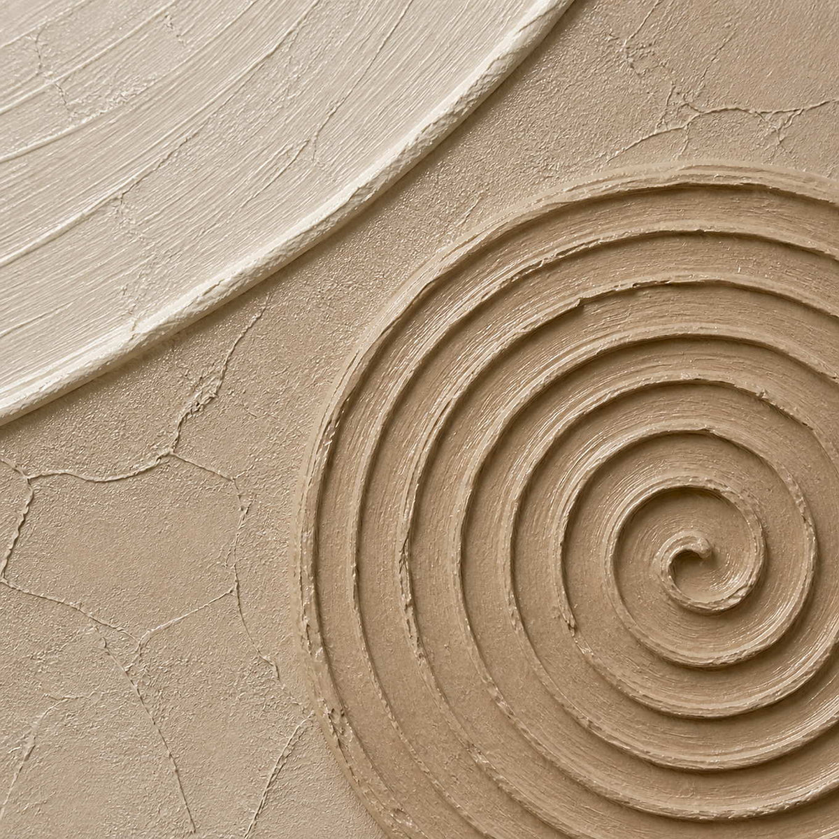 Close-up of sculpted warm stone spiral relief and hand-painted surface texture.