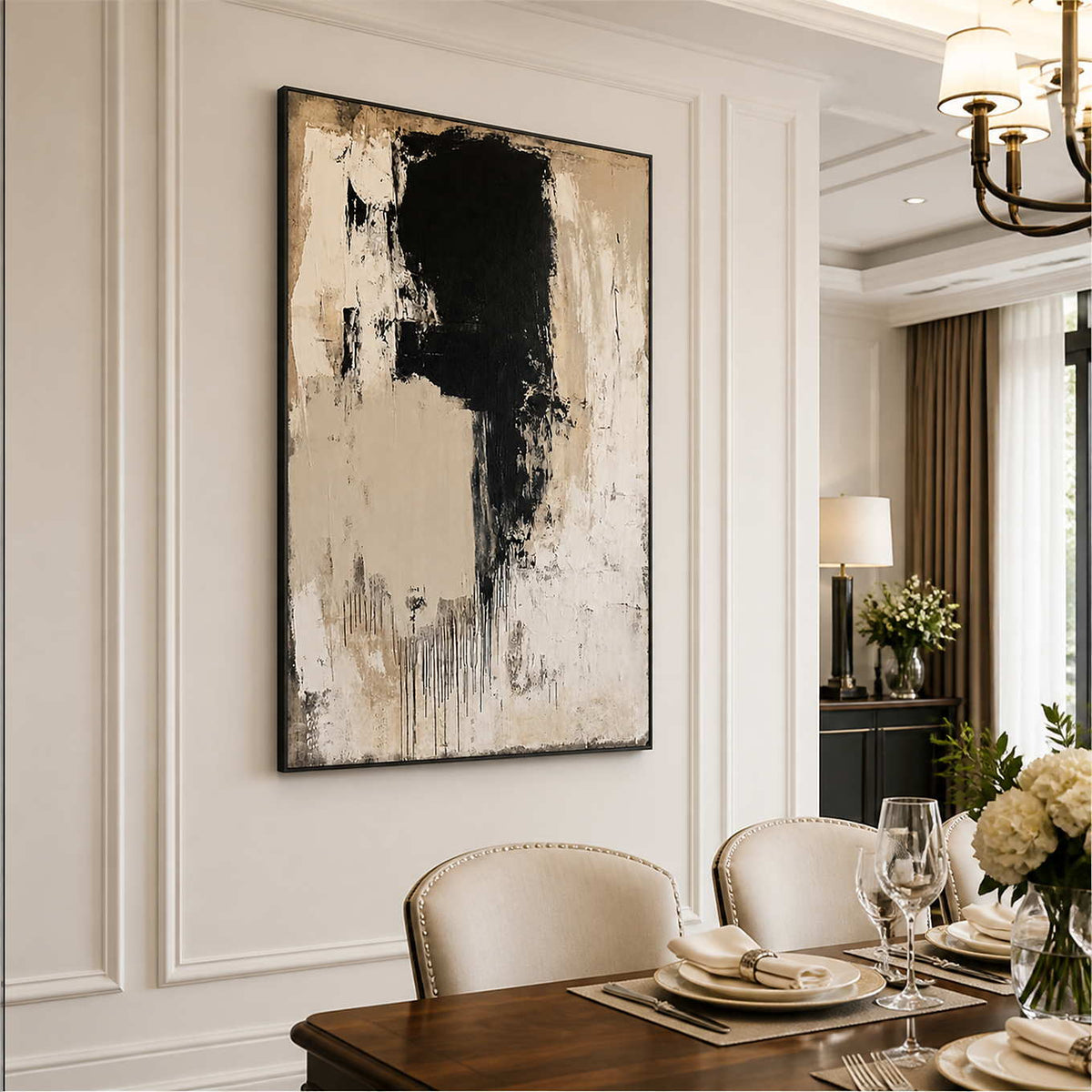 Black framed gestural abstract beside a dining table set with white plates.