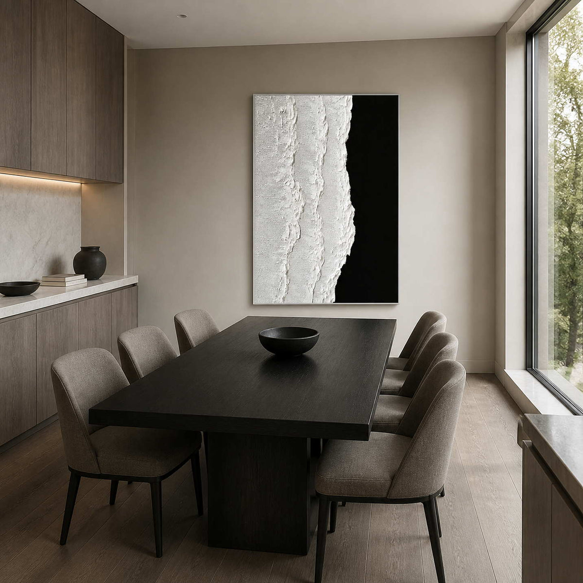 Silver framed black and white abstraction beyond a dark dining table with gray chairs.