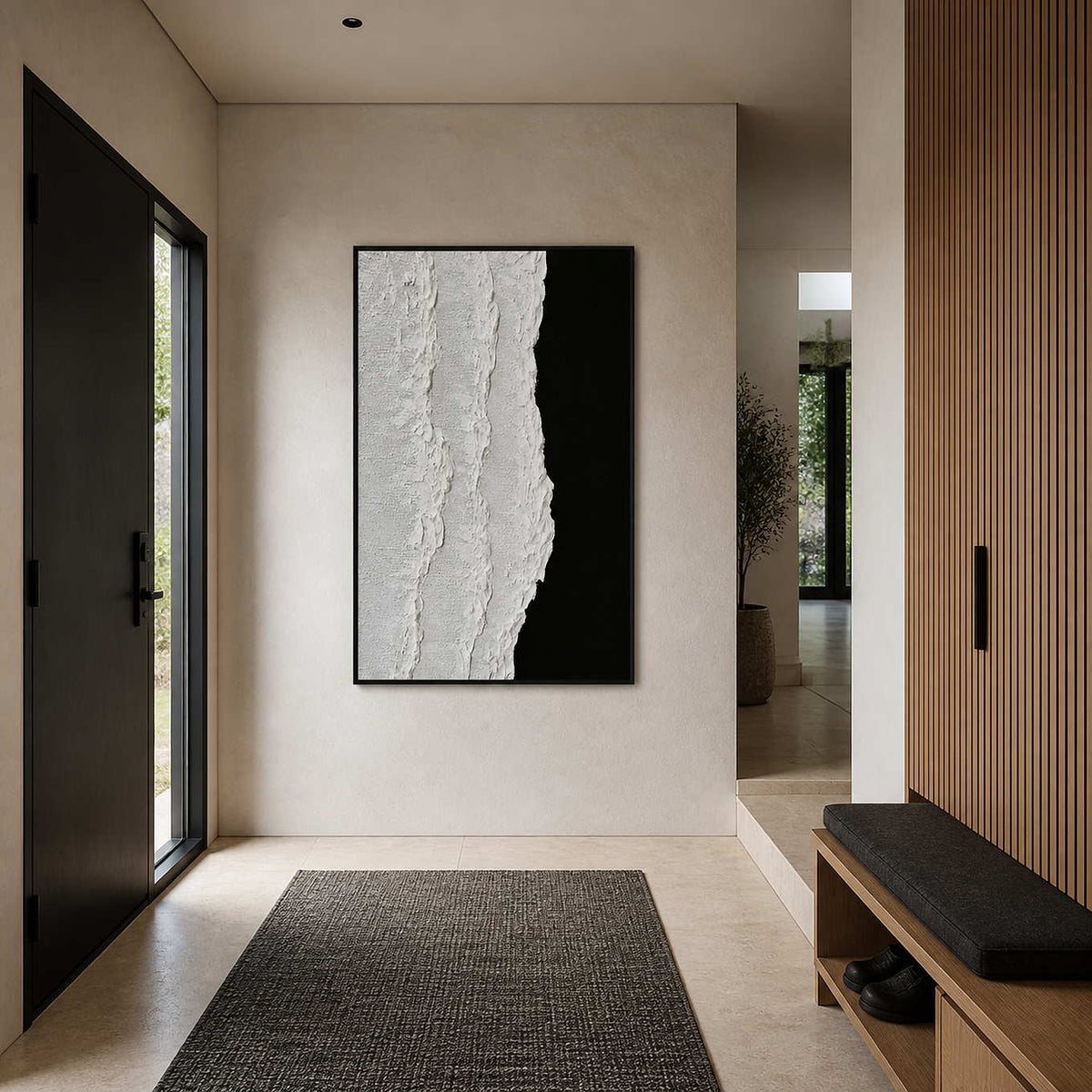 Black framed textured abstraction beside a dark entrance door and a slatted wooden bench.