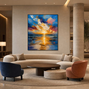 Large sunset seascape anchoring a contemporary coastal hotel lobby.