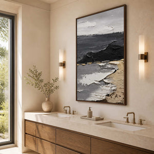 Wood framed gray and white coastal artwork above a bright double vanity.