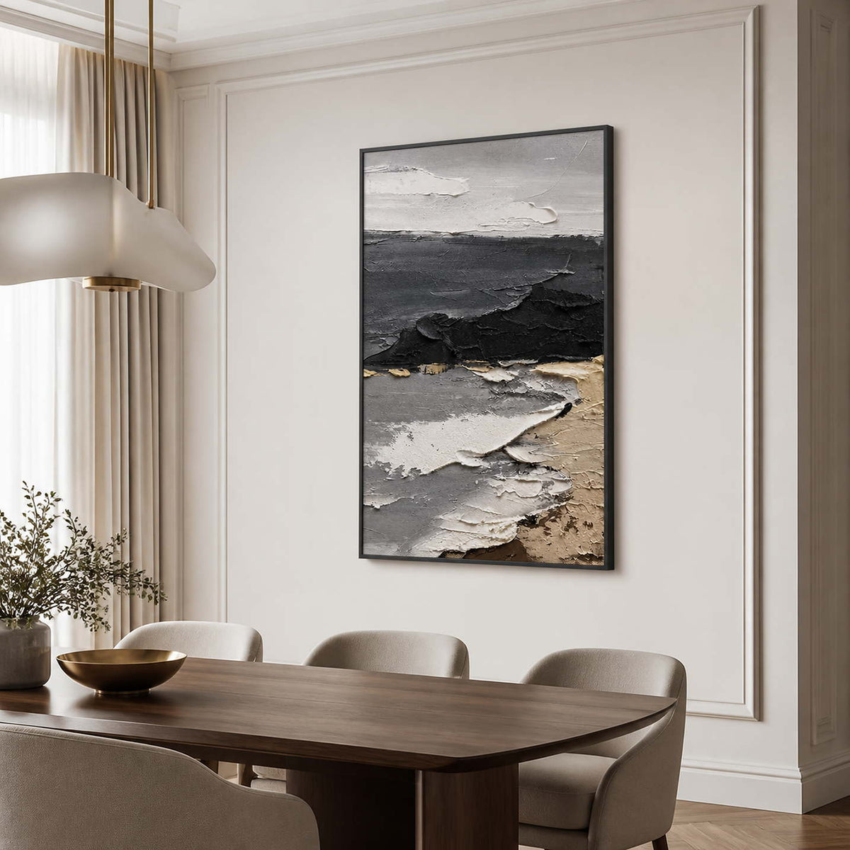 Black framed gray coastal artwork above a dark dining table with cream chairs.
