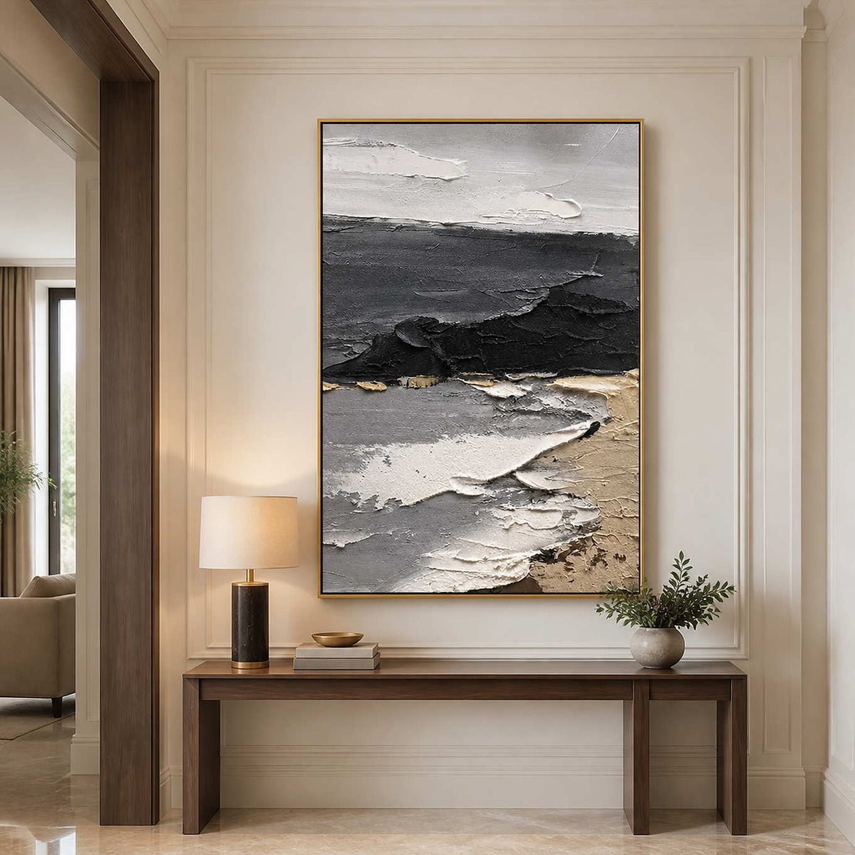 Gold framed coastal abstract painting above a slim wooden console in a hallway.