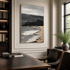 Silver framed gray abstract painting behind a leather chair in a dark wooden study.
