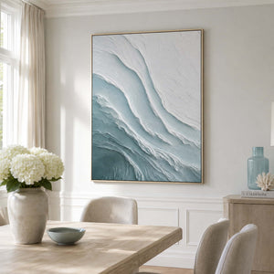 Vertical coastal artwork in a light neutral dining room
