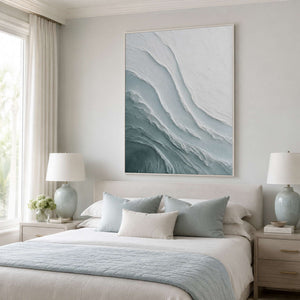 Textured ocean wall art above a soft blue bedroom