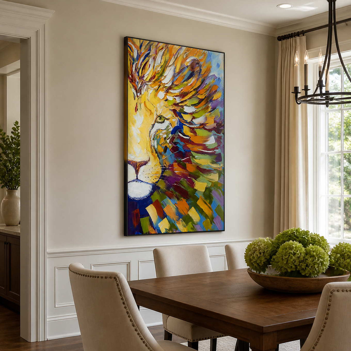 Black framed colorful lion painting beside upholstered chairs in a sunlit dining room.