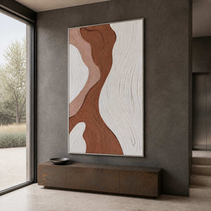 Silver framed brown and white abstract artwork above a dark entryway console.