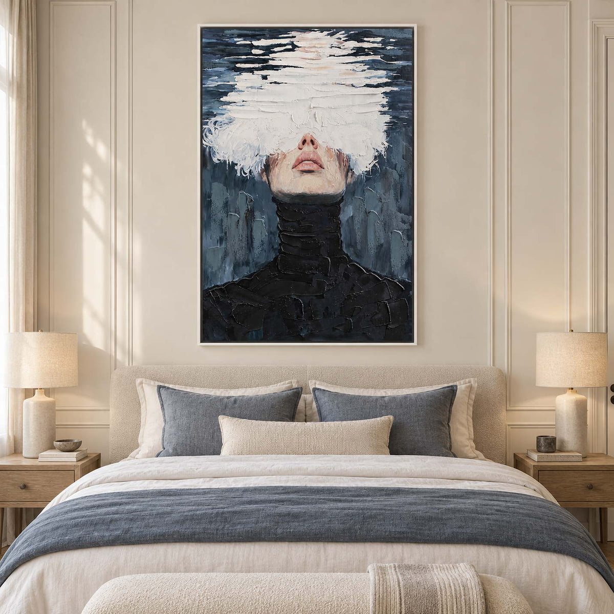 White-obscured portrait over a cream bed with blue-gray throw and pillows.