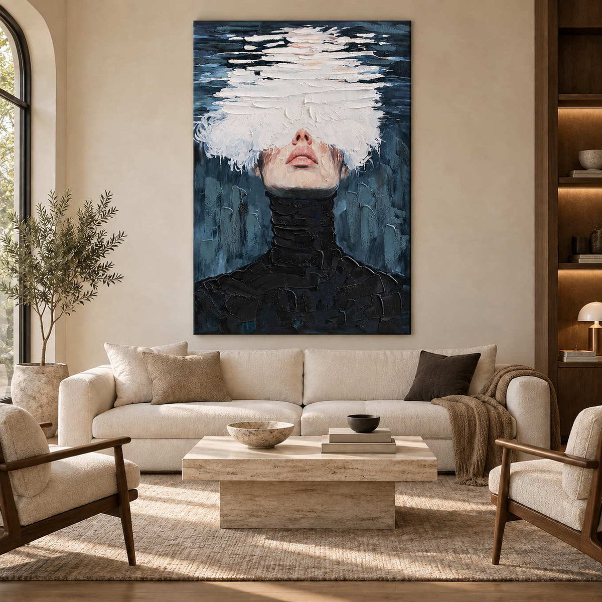 White-layered face portrait above a cream sofa and pale block coffee table.