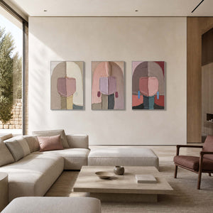 Figurative wall art triptych displayed in a soft contemporary living room.