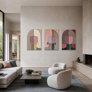 Modern figurative wall art set viewed in a gray-blue living room.