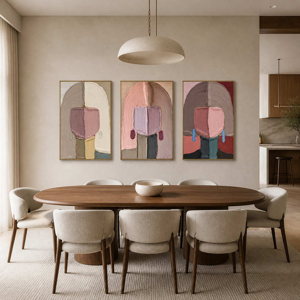 Textured figurative triptych displayed above a warm contemporary dining room.