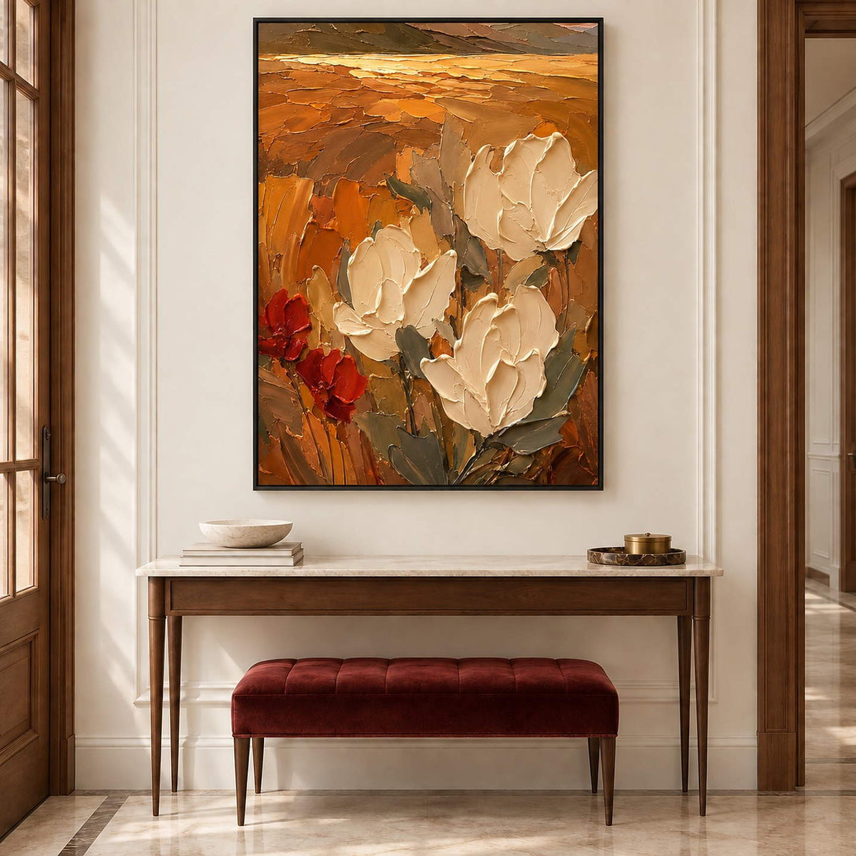 Textured cream flowers painting against an amber and rust background in a black frame in an entryway.
