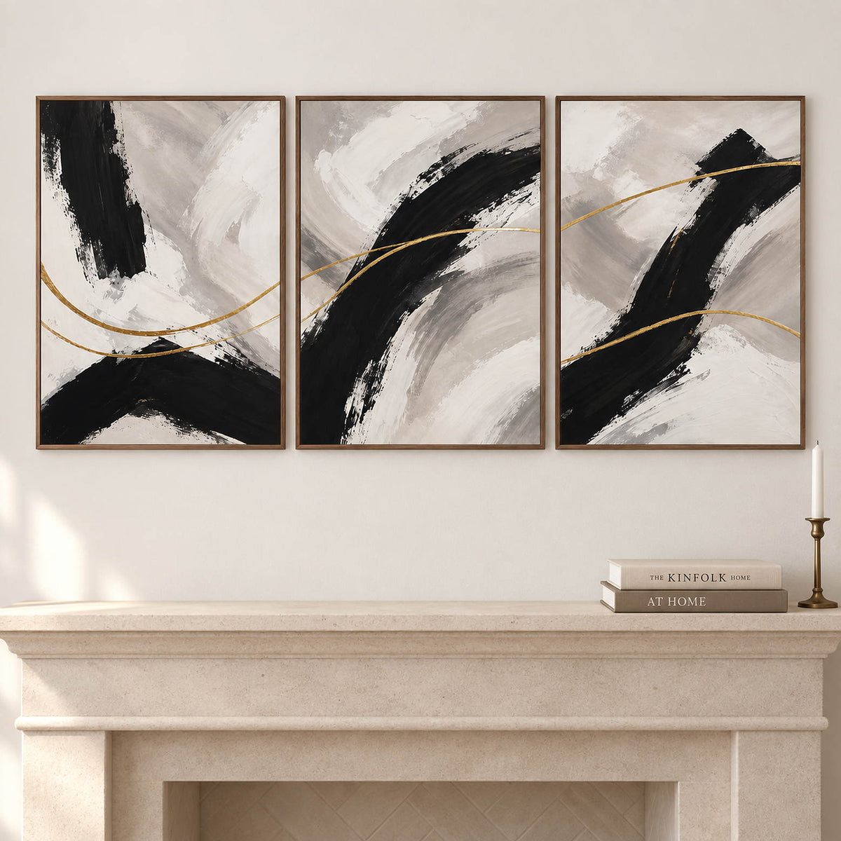 Three vertical abstract panels with black gestures, ivory fields, and gold lines, displayed beside or above a fireplace with brown wood frames.
