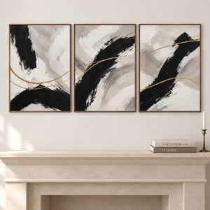 Three vertical abstract panels with black gestures, ivory fields, and gold lines, displayed beside or above a fireplace with brown wood frames.