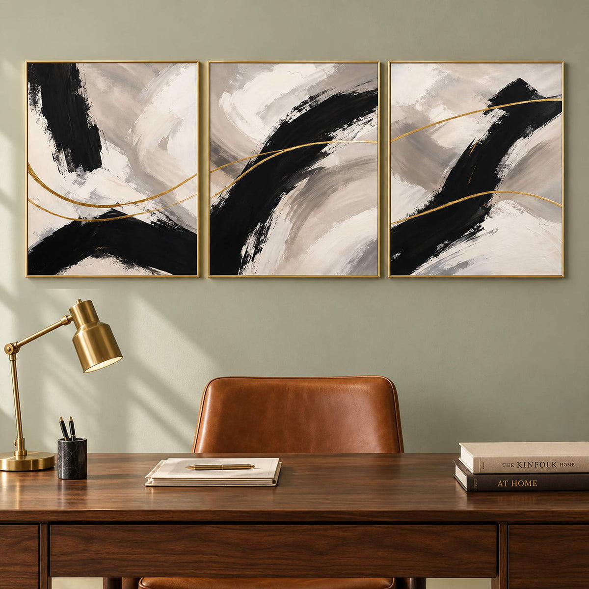 Three vertical abstract panels with black gestures, ivory fields, and gold lines, displayed in a study with gold frames.