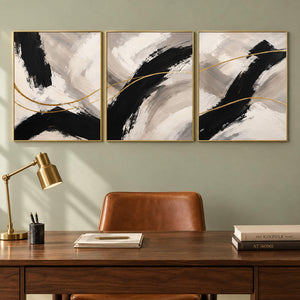 Three vertical abstract panels with black gestures, ivory fields, and gold lines, displayed in a study with gold frames.
