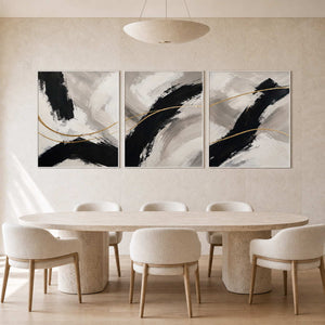 Black ivory and gold triptych displayed in a bright modern dining room.