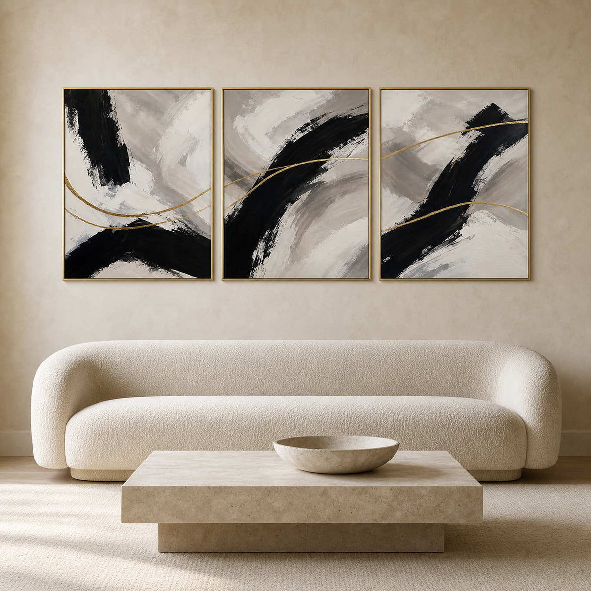 Abstract black and gold triptych displayed in a refined neutral living room.