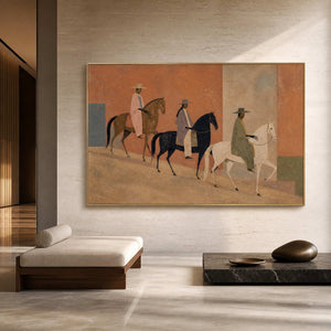 Modern horse rider artwork in a gold frame inside a warm lobby.