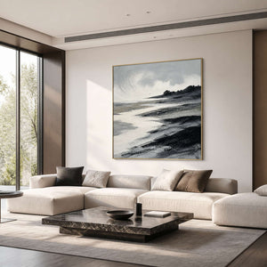 Textured monochrome coastal wall art in a refined living room with a gold frame.