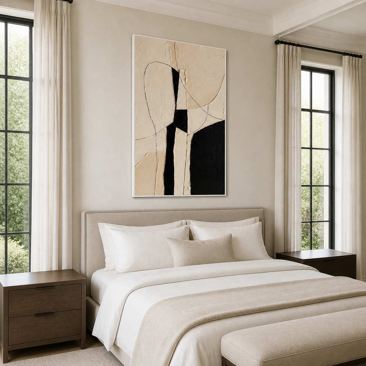 White framed monochrome abstract painting above a pale bed between tall windows and curtains.