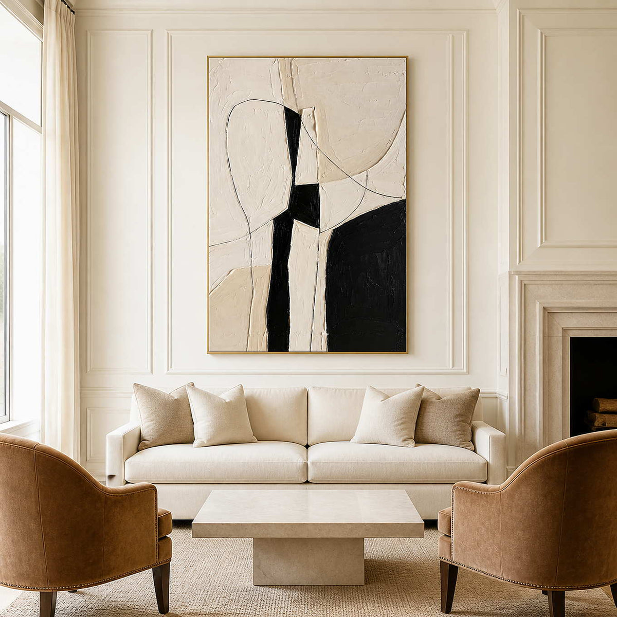 Gold framed ivory and black artwork above a cream sofa between warm brown armchairs.